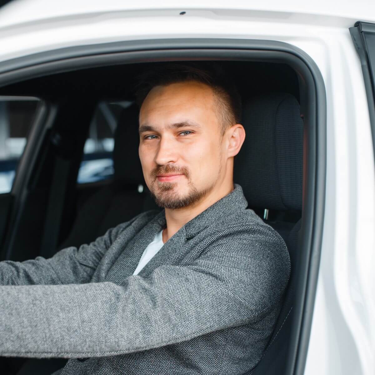 man-sitting-in-new-car-showroom-N4FPK8S.jpg